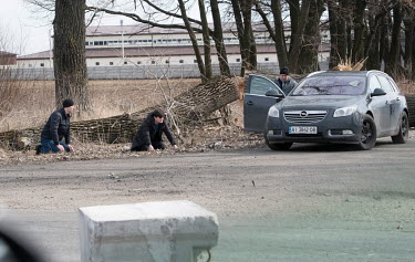 Two men suspected of being Russians are held on the outskirts of Brovary while their car searched.