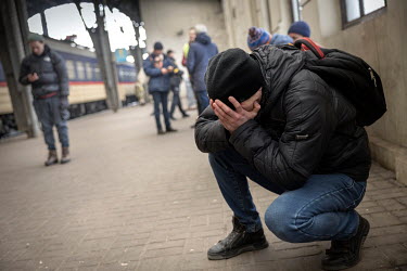 Evgeni holds his hands to his face as he collapses in tears after saying farewell to his love Antonina at the train station in Lviv.  Under martial law, men aged 18 to 60 are not allowed to leave Ukra...