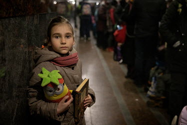 Evgenia (6) clutches her favourite toy and fairytale book, the two things that she was allowed to take before fleeing her home in Borispol.  Lviv's train station is the main hub for people trying to e...