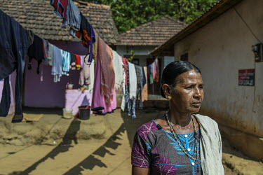 Sita, 60 was widowed when her husband Kenchan, a forest ranger, died in an elephant attack four years ago. She stands outside her house in her village in Thhurambur.