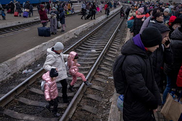 Refugees arriving in Lviv trying to leave the train they have just come in on and hurry to catch the next departing service to Poland.  The station at Lviv is the main hub for people trying to escape...