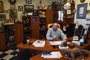 The Director of Mykolaiv Zoo Vladimir Topchy sits at his desk in his office as he tries to keep the zoo going although it has been hit by four Russian rockets.
