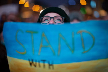 A young woman holds a blue and yellow 'Stand with Ukraine' sign during a protest in Wenceslas Square against the Russian invasion of Ukraine. Ukrainian President Volodymyr Zelensky addressed crowds in...