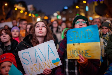 Two women hold blue and yellow signs in support of Ukraine during a protest in Wenceslas Square against the Russian invasion. Ukrainian President Volodymyr Zelensky addressed crowds in several Europea...