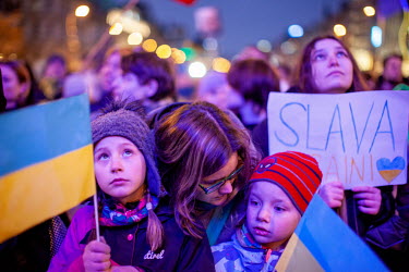 A mother and her children, holding an Ukrainian flags, stand among the thousands of people gathered in Prague's Wenceslas Square to protest the Russian invasion of Ukraine. Ukrainian President Volodym...