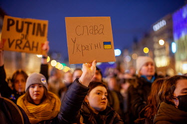 A woman holds a sign in Czech that reads: 'Putin is a murderer' as thousands of people gathered in Prague's Wenceslas Square to protest the Russian invasion of Ukraine. Ukrainian President Volodymyr Z...