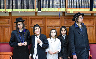 A group of Hasidic boys in a synagogue.