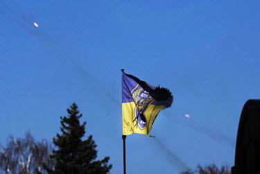 Outgoing anti air attack ordinance traces a line through the sky behind a Ukranian flag flying in west Kyiv. The anti misile defence systems have proved quite effective in the skies above Kyiv.