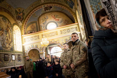 Military comrades and local residents of the village of Soposhyn gather for the funeral of Roman Ruschyshyn (44), a former police officer who was killed on 7 March 2022 during a battle with invading R...