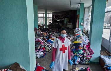 A nurse helping distribute donations at the Circus building which has become a distribution centre. Internally displaced persons, mostly from Mariupol, and many of whom fled the war without any posses...