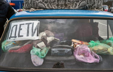 A private car displaying a sign reading 'Children' arrives in the relative safety of Zaporozhie after fleeing besieged Mariupol. Arrivals have to go through the Epicentr supermarket, where they are re...