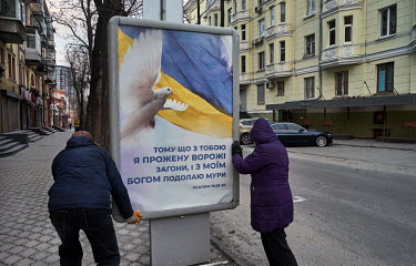 A poster with an Ukrainian national flag with peace dove that reads: 'Because with you, I will drive out enemy troops, and with my god I will overcome the walls. Psalm 18:20:30'
