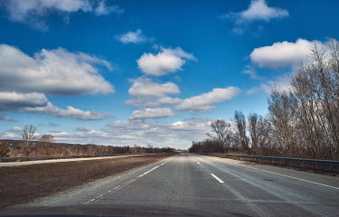 An empty highway from Dnipro to Kharkov. Occasionally, there are some private cars, with signs reading 'Children' displayed in their windows, who fleeing Russian bombs in the Saltivka (northen part) d...