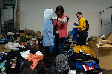 Volunteers organise clothes donated for internally displaced people (IDPs) and communities affected by the Russian invasion of Ukraine. The items are sorted, organised and distributed at the Potozki P...