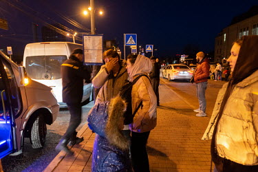 Evacuees from Chernigiv arrive by mini bus at the Central Railway station.