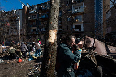 Residents and city employees clean up debris after civilian, residential areas of western Kiev were targeted by Russian shelling over several days in the third week of Russia's invasion of Ukraine.