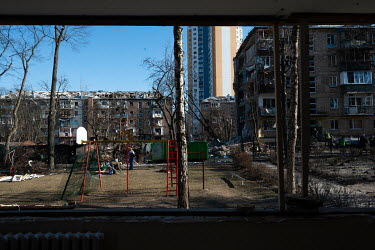 People clear the children's playground area in a residential housing estate, one of several civilian, residential areas of western Kiev that were targeted by Russian shelling over several days in the...
