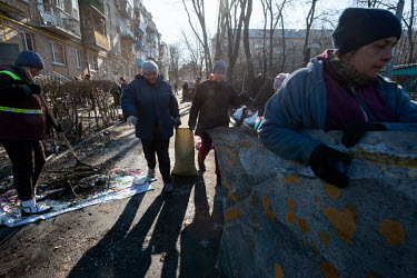 Residents and city employees clean up debris after civilian, residential areas of western Kiev were targeted by Russian shelling over several days in the third week of Russia's invasion of Ukraine.
