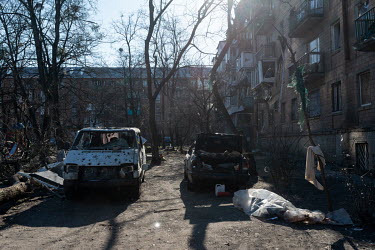 Badly damaged vehicles in a bomb-damaged residential housing estate, one of several civilian, residential areas of western Kiev that were targeted by Russian shelling over several days in the third we...