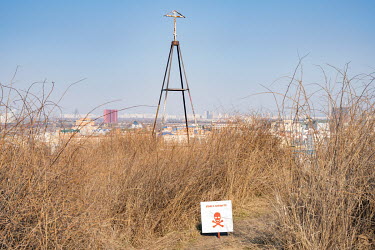 A warning sign indicating the prescence of mines placed on hills overlooking the city.