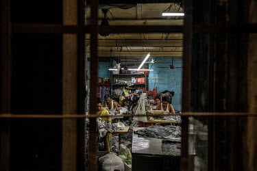 People working in a small factory in the Dharavi slum despite the city being in lockdown.