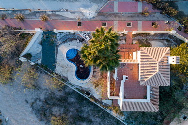 An abandoned and decrepit house seen from above at La Tercia Real housing complex.
