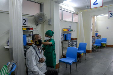 A man is given a COVID-19 vaccination at vaccination centre in a government-run hospital. Not many people attended the clinic that day because it was the first day of the second lockdown in Mumbai and...