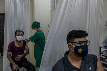 People are given a COVID-19 vaccination at vaccination centre in a government-run hospital. Not many people attended the clinic that day because it was the first day of the second lockdown in Mumbai a...
