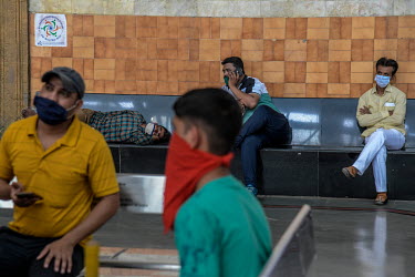 Passengers wait at the CST railway station.