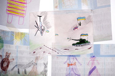 A child's drawing of an Ukrainian tank shooting down a Russian helicopter on a wall display at the arrivals centre at the Hauptbahnhof, the railway station where Ukrainian refugees disembark trains fr...