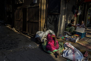 A homeless woman sleeps on the streets of South Mumbai during the second COVID-19 lockdown.sleep