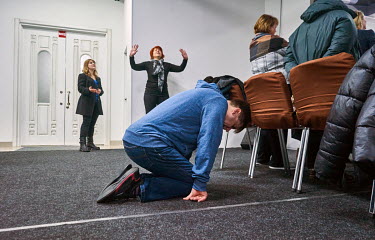 A man kneels to pray Ukrainian during a Sunday service in the Door to Heaven (Dveri v Nebo) Christian Church. There are services at the church everyday where believers pray for peace, for Ukraine, for...
