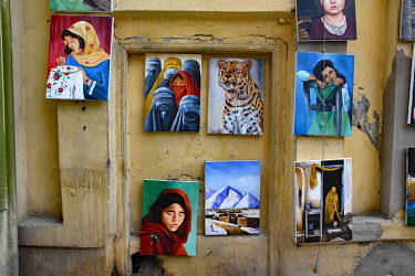 A souvenir art shop on Chicken Street selling paintings, such as a copy of the famous green-eyed girl from the National Geographic cover by Steve McCurry.