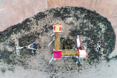 An abandoned child's playground seen from above at the Solar City of Soto de Monteluz.