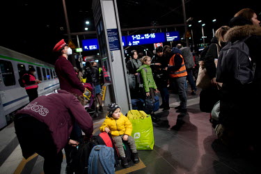 Ukrainian refugees disembark a train from Poland that has just arrived at the Hauptbahnhof, Berlin's main railway station.