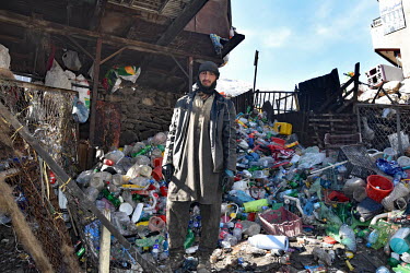 A man recycling plastics and scrapmetal.
