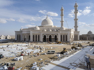 Workers are tiling a courtyard in front of the new Misr Mosque in Egypt's New Administrative Capital. The Misr Mosque will be one of the largest mosques in the world able to accomodate more than 100,0...