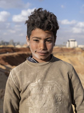 A child worker at the People's Square construction site in Egypt's New Administrative Capital.  Following persistent problems of overpopulation, pollution and traffic congestion, the construction of a...