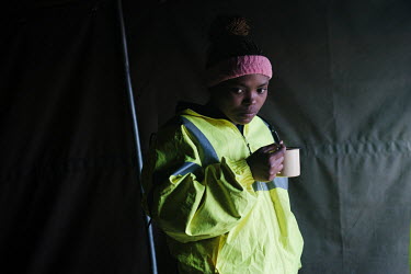 Nobuhle Jali, a member of a high-angle tree clearing team, enjoying an early morning cup of coffee before the start of the day at her team's campsite in a remote montane catchment area that feeds the...