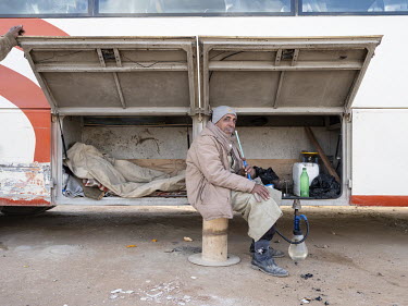 A bus driver smoking a shisha while waiting to drive workers back home from Egypt's New Administrative Capital. Following persistent problems of overpopulation, pollution and traffic congestion, the...