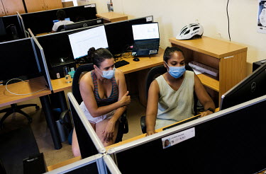 Joicymara Santos Xavier (left) and Nikita Sitharam, postgraduate students studying under bioinformatician Prof. Tulio de Oliveira, in their workspace at the South African Centre for Epidemiological Mo...