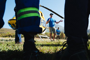 Helicopter pilot Roedolf de Lange briefing members of high-angle tree clearing teams on how to safely exit the helicopter before deploying them to montane watersheds that feed the Greater Cape Town ar...