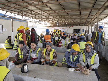 Workers eat lunch at the labour camp near the newly built Fifth Residential Neighbourhood (R5) in Egypt's New Administrative Capital. Following persistent problems of overpopulation, pollution and tr...