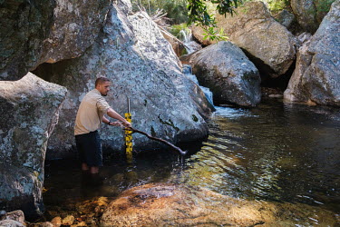 Richard Bugan, Monitoring and Evaluation Manager at The Nature Conservancy South Africa, checking equipment that monitors water flow in a stream in a remote catchment area that feeds the Theewatersklo...