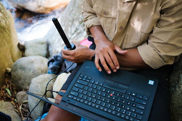 Richard Bugan, Monitoring and Evaluation Manager at The Nature Conservancy South Africa, downloading data from a remote probe that monitors water flow in a stream in a remote catchment area that feeds...