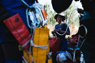 Team Leader Zikhona Gcakamani as she and the high-angle tree clearing team she leads check their equipment in preparation for the following day's work, at their campsite in a remote montane catchment...