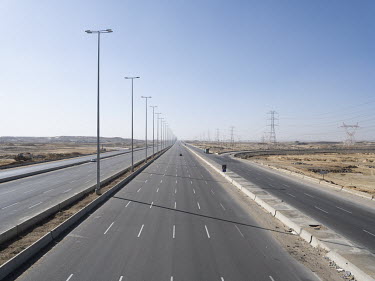 An empty 16 lane highway in Egypt's New Administrative Capital. Following persistent problems of overpopulation, pollution and traffic congestion, the construction of a giant new satellite city in th...