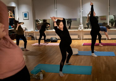 Belinda Navi (centre) attending her first pregnancy yoga session, one of the most popular classes at Auour Bjarnadottir's studio in Reykjavik. On a Thursday evening, Marta Karen Kristjonsdottir leads...
