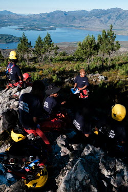 Khanya Bovungana (centre rear), a Rope Technician and one of two Health & Safety Officers on a high-angle tree clearing team, leading a safety meeting before the team gets to work in a remote montane...