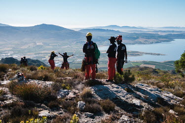 Members of a high-angle tree clearing team enjoy the view and take photos as other members of the team scout out the exact locations they will focus on in a remote montane catchment area that feeds th...